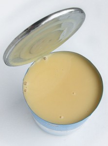 an open tin of condensed milk sgushenka